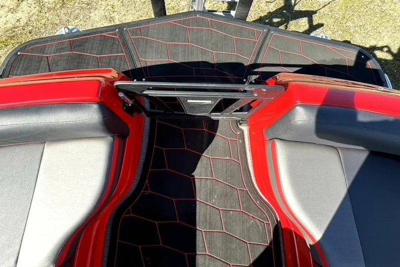  Yacht Photos Pics 2022 Manitou XT 27 SRW boat interior with red and black seating and flooring.