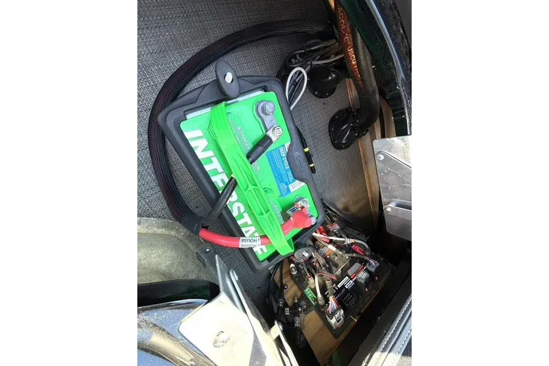  Yacht Photos Pics Battery compartment of a 2022 Manitou XT 27 SRW with Interstate battery and wiring.