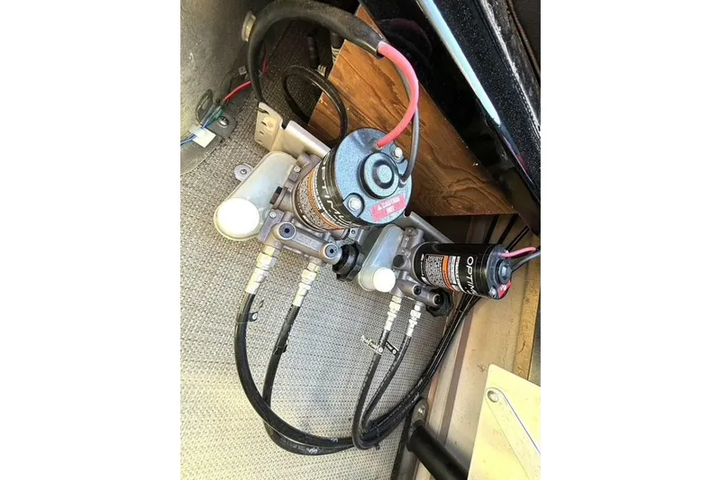  Yacht Photos Pics Hydraulic system components of a 2022 Manitou XT 27 SRW, featuring hoses and connectors.