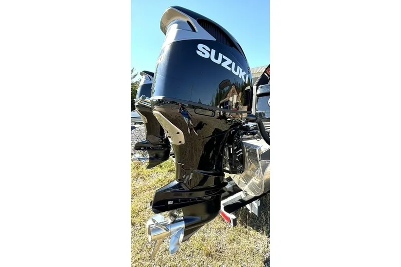 Yacht Photos Pics 2022 Manitou XT 27 SRW with Suzuki outboard motor, shiny black finish, outdoor setting.