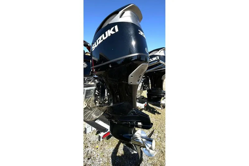  Yacht Photos Pics Outboard motor on a 2022 Manitou XT 27 SRW boat, featuring Suzuki branding.