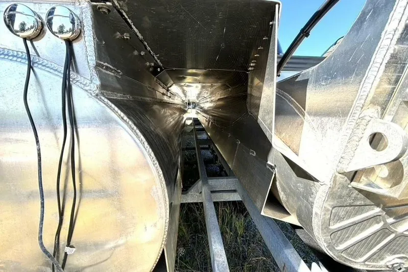  Yacht Photos Pics 2022 Manitou XT 27 SRW pontoon boat undercarriage, showcasing aluminum structure and wiring.