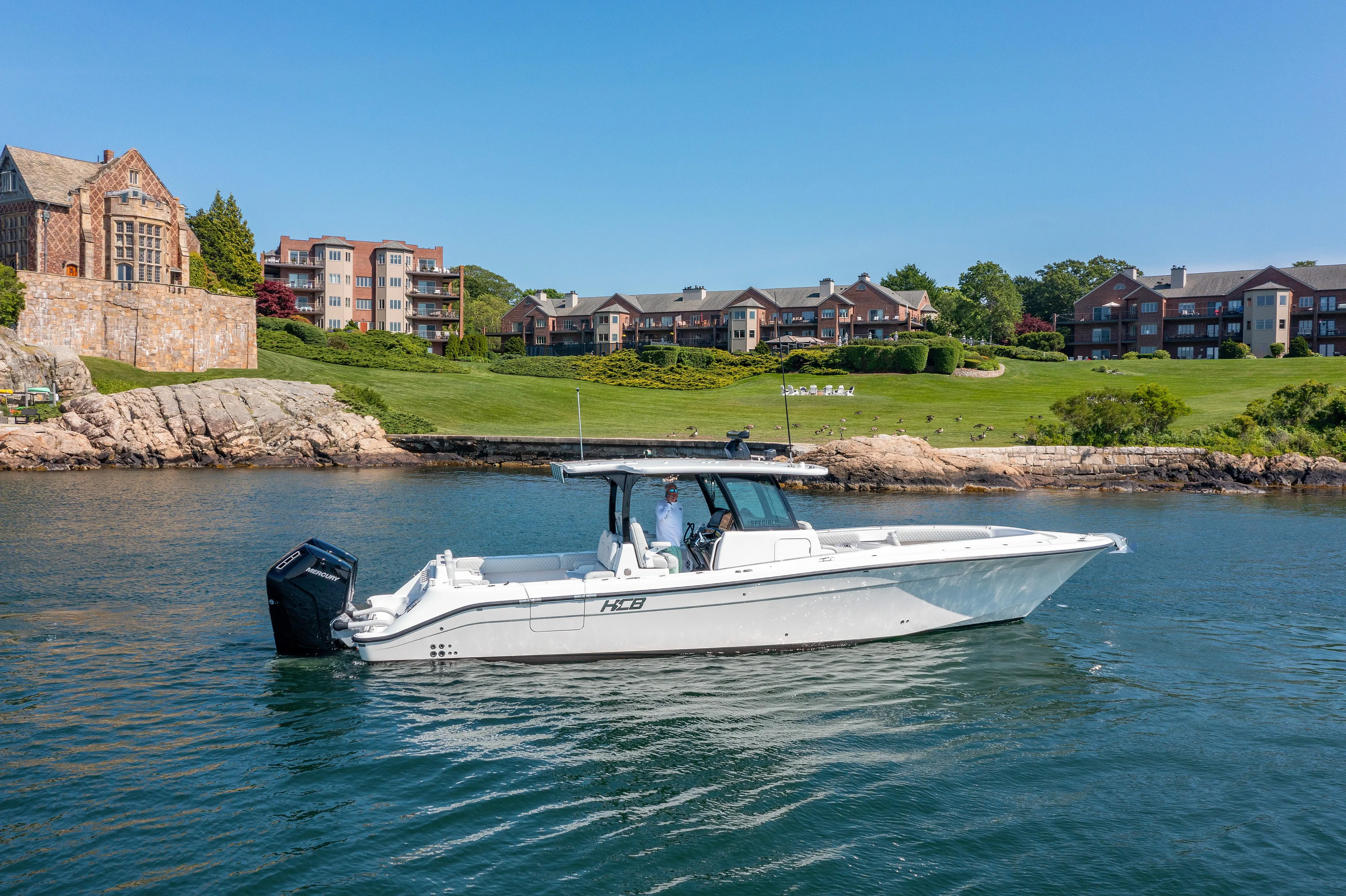  Yacht Photos Pics 2024 HCB 39 Speciale boat cruising near waterfront homes.