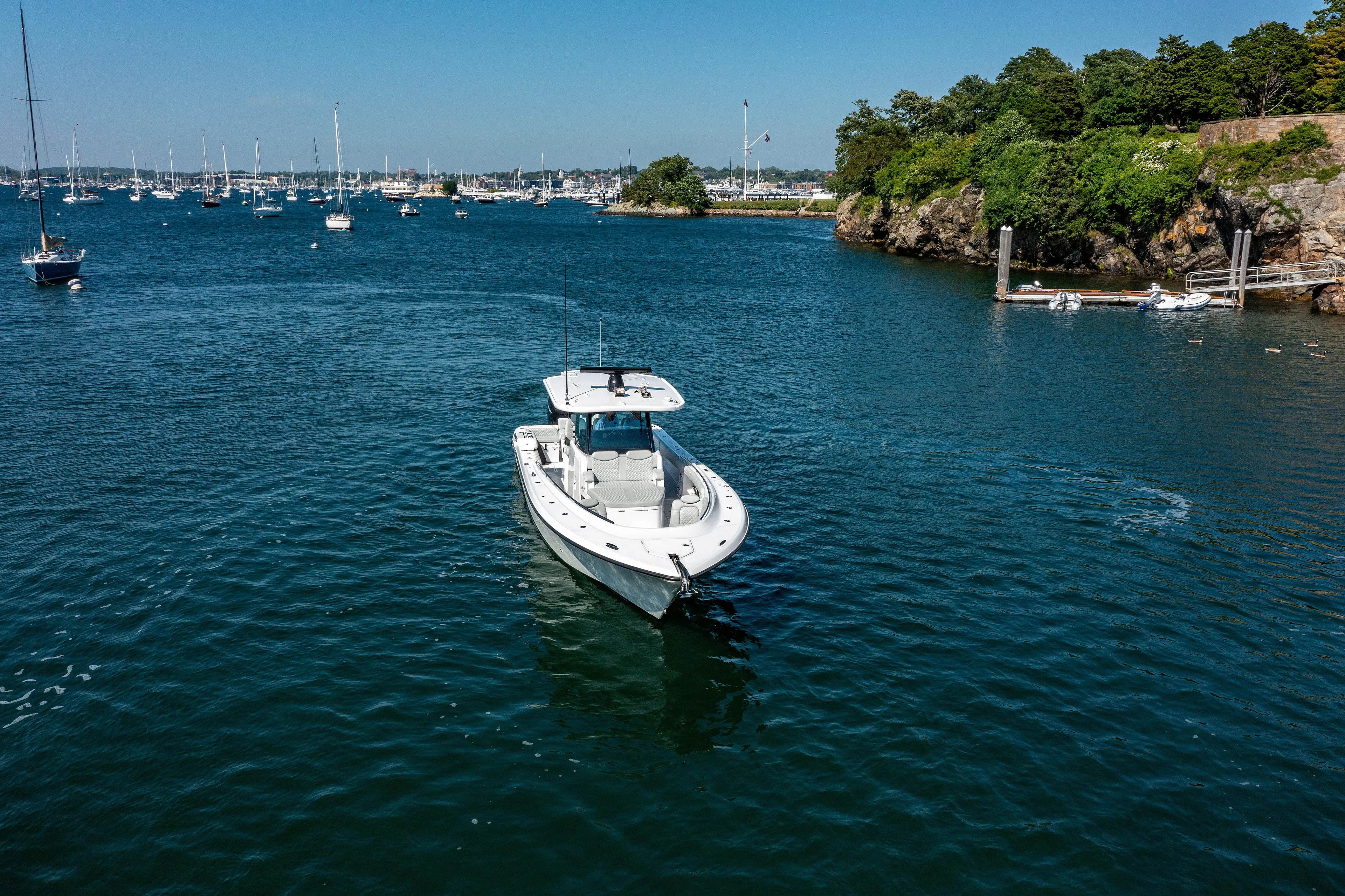  Yacht Photos Pics 2024 HCB 39 Speciale boat cruising in a scenic harbor.