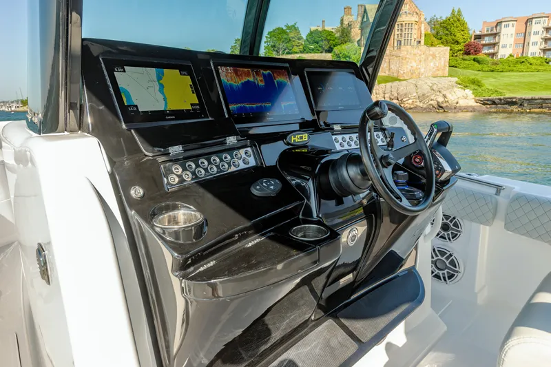  Yacht Photos Pics HCB 39 Speciale 2024 boat dashboard with navigation screens and steering wheel.