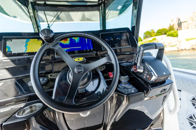  Yacht Photos Pics 2024 HCB 39 Speciale boat dashboard with steering wheel and navigation screens.