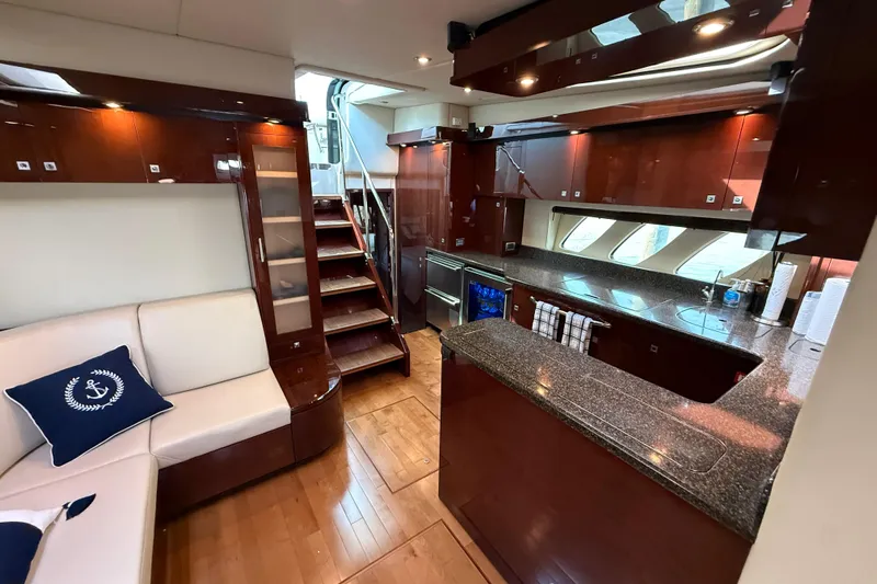 Positive Vibes Yacht Photos Pics Luxurious interior of 2008 Sea Ray 550 Sundancer yacht with modern kitchen and seating area.