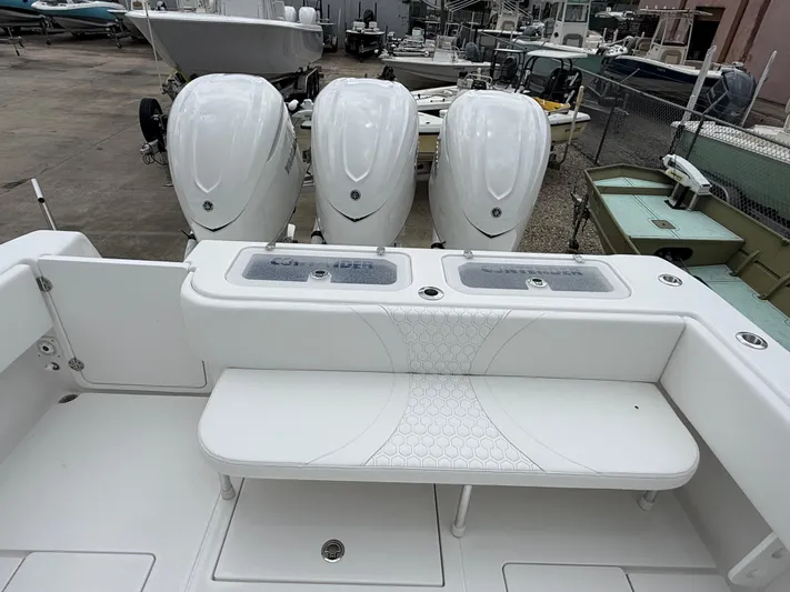  Yacht Photos Pics 2026 Contender 39 ST boat with triple outboard engines, white seating, and fishing deck.