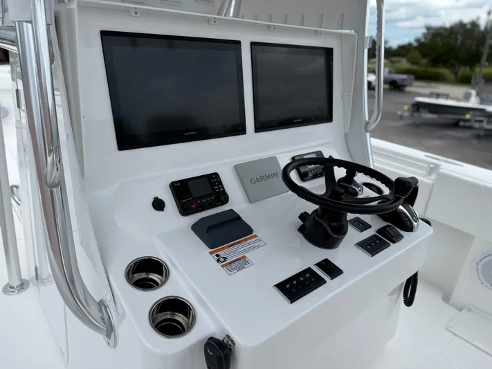  Yacht Photos Pics Control panel of 2026 Contender 39 ST boat with dual Garmin screens and steering wheel.