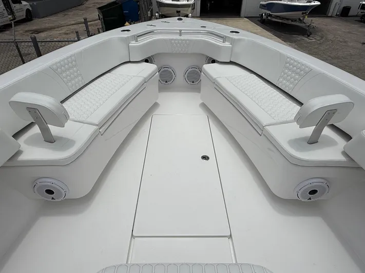  Yacht Photos Pics 2026 Contender 39 ST boat interior with white cushioned seating and speakers.