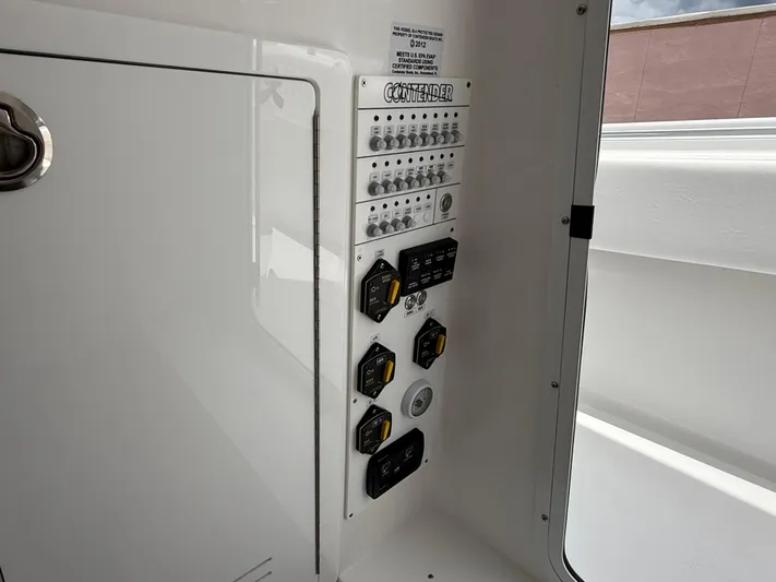  Yacht Photos Pics Control panel of 2026 Contender 39 ST boat, featuring switches and dials.