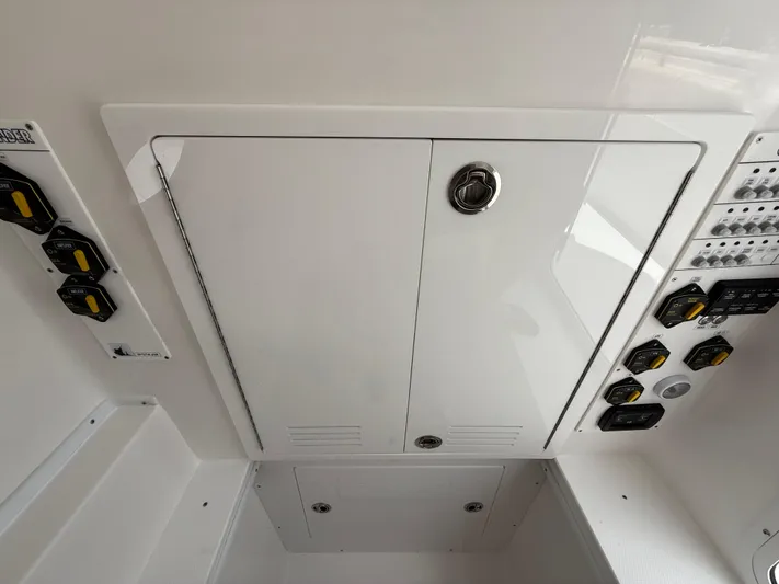  Yacht Photos Pics 2026 Contender 39 ST boat control panel with switches and storage compartment.