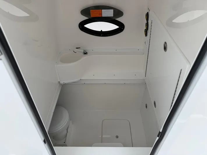  Yacht Photos Pics Interior of 2026 Contender 39 ST boat cabin with compact bathroom amenities.