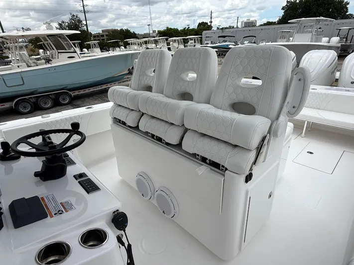  Yacht Photos Pics 2026 Contender 39 ST boat interior with white cushioned seats and steering console.