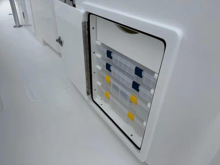  Yacht Photos Pics Storage compartment with organized tackle boxes on a 2026 Contender 39 ST boat.