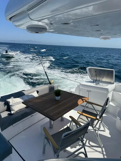  Yacht Photos Pics 2009 Sealine F42/5 yacht deck with seating, table, and ocean view.