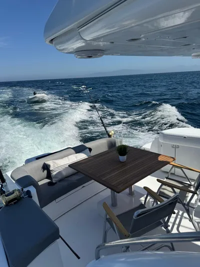  Yacht Photos Pics 2009 Sealine F42/5 yacht deck with seating, table, and ocean view.