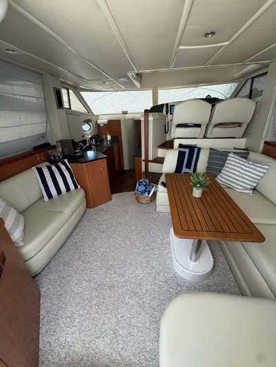  Yacht Photos Pics 2009 Sealine F42/5 yacht interior with plush seating and wooden table.