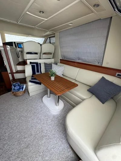  Yacht Photos Pics 2009 Sealine F42/5 yacht interior with plush seating and wooden table.