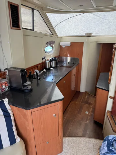  Yacht Photos Pics 2009 Sealine F42/5 yacht interior with modern kitchen and wooden cabinetry.