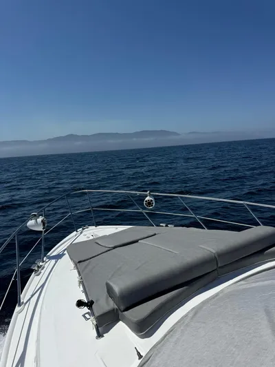  Yacht Photos Pics 2009 Sealine F42/5 yacht cruising on open sea under clear blue sky.