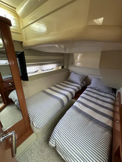  Yacht Photos Pics 2009 Sealine F42/5 yacht interior with twin beds and striped bedding.