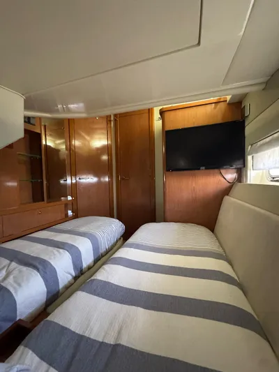  Yacht Photos Pics Interior of 2009 Sealine F42/5 yacht with twin beds and wall-mounted TV.