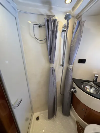  Yacht Photos Pics 2009 Sealine F42/5 yacht bathroom with shower, curtain, and modern sink.