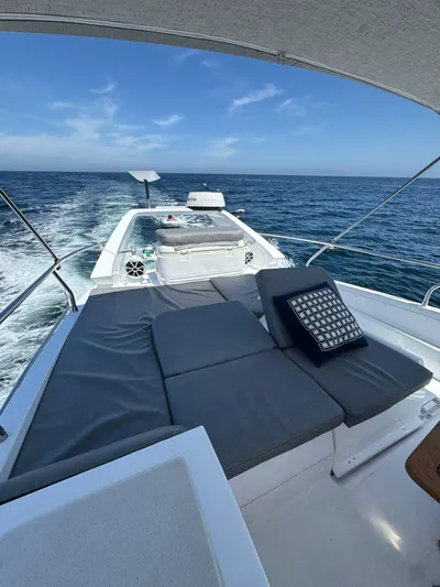  Yacht Photos Pics 2009 Sealine F42/5 yacht cruising on open sea with sun deck and cushions.