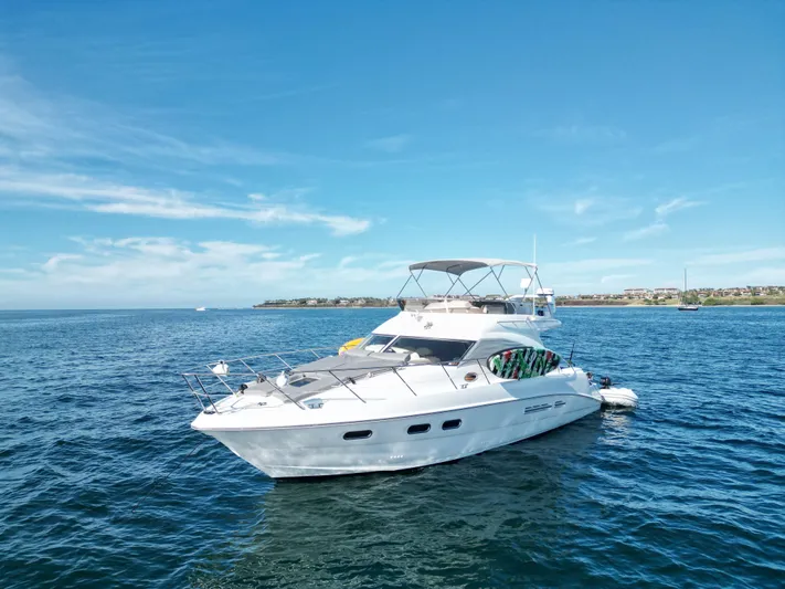  Yacht Photos Pics 2009 Sealine F42/5 yacht cruising on open water under clear blue skies.
