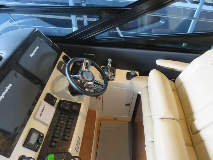 Sea-f-o Yacht Photos Pics 2015 Sea Ray 470 Sundancer helm with Raymarine electronics and beige seating.