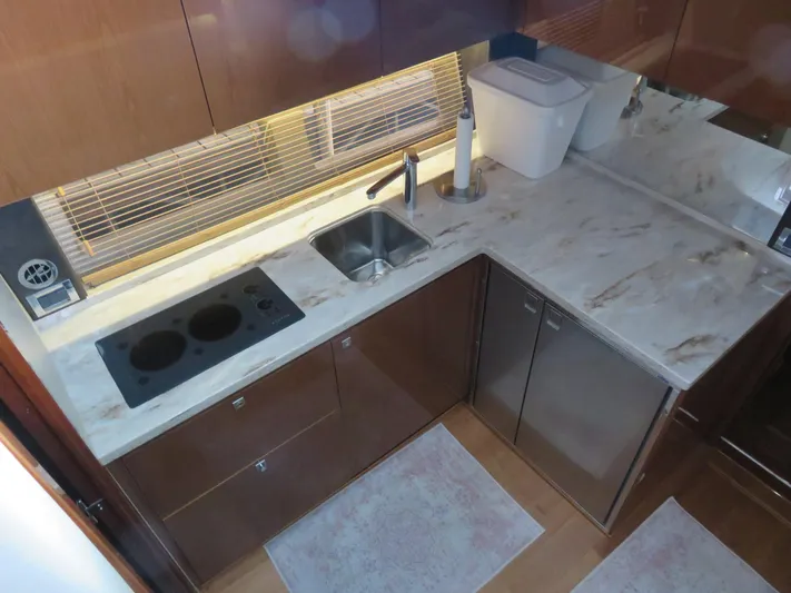 Sea-f-o Yacht Photos Pics Modern kitchen in 2015 Sea Ray 470 Sundancer yacht with marble countertops and stove.