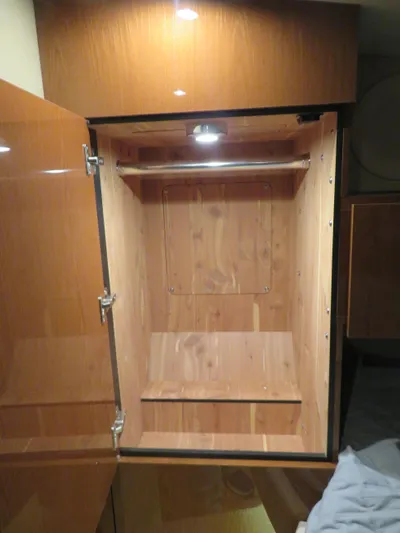 Sea-f-o Yacht Photos Pics Wooden closet interior on 2015 Sea Ray 470 Sundancer yacht, illuminated by overhead light.
