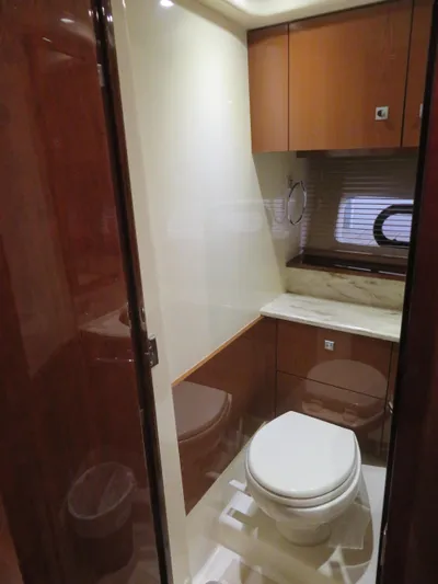 Sea-f-o Yacht Photos Pics 2015 Sea Ray 470 Sundancer yacht bathroom with modern fixtures and wood cabinetry.