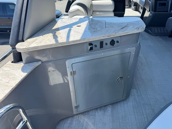  Yacht Photos Pics Interior of 2025 Avalon Excalibur 27' boat with sleek countertop and storage compartment.