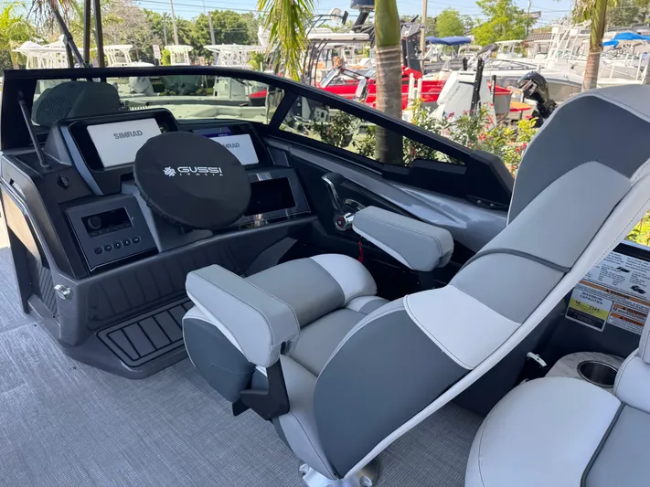  Yacht Photos Pics 2025 Avalon Excalibur boat interior with modern dashboard and comfortable seating.