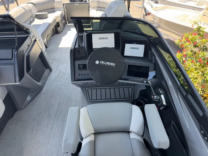  Yacht Photos Pics 2025 Avalon Excalibur 27' boat interior with modern dashboard and seating.