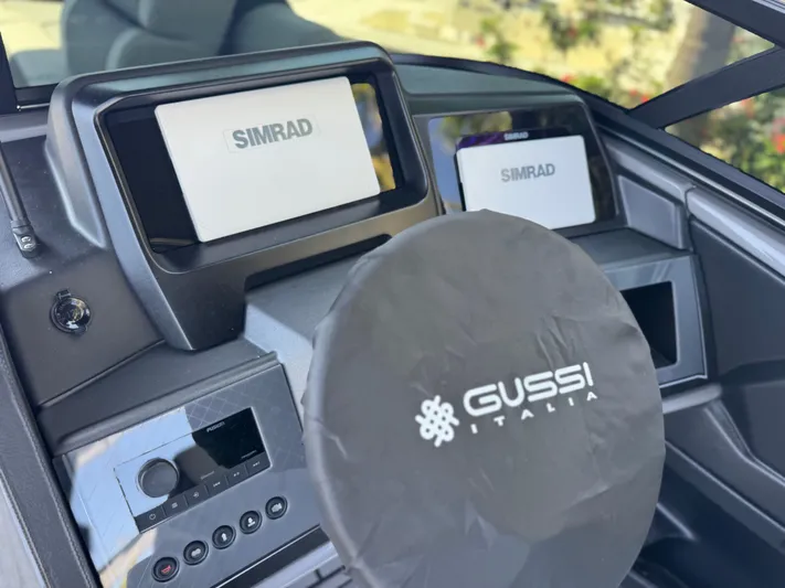  Yacht Photos Pics 2025 Avalon Excalibur boat dashboard with Simrad displays and Gussi Italia steering wheel.
