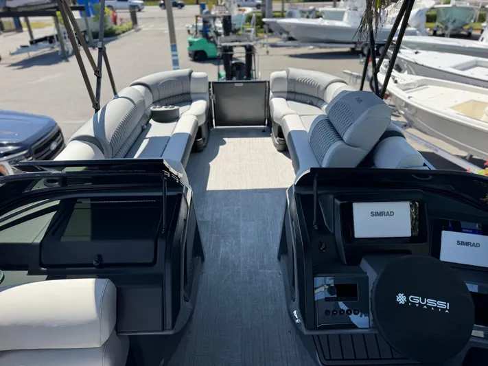  Yacht Photos Pics 2025 Avalon Excalibur 27' boat interior with luxurious seating and advanced navigation systems.