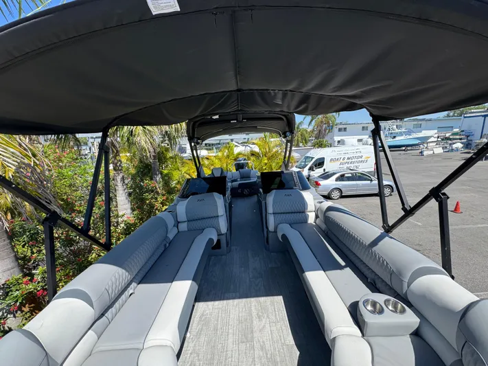  Yacht Photos Pics 2025 Avalon Excalibur 27' pontoon boat with spacious seating and canopy in a marina setting.
