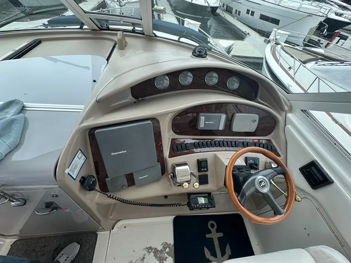 Ballerina Yacht Photos Pics 2004 Sea Ray 390 Motor Yacht helm with wood accents and modern navigation equipment.