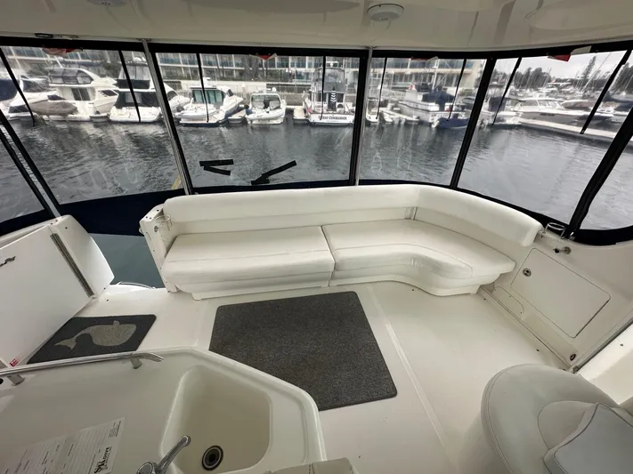 Ballerina Yacht Photos Pics 2004 Sea Ray 390 Motor Yacht interior with white seating and marina view.