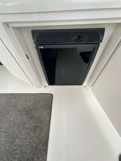 Ballerina Yacht Photos Pics 2004 Sea Ray 390 Motor Yacht interior with compact black refrigerator.