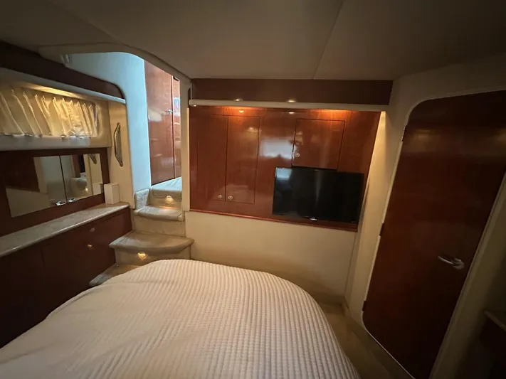 Ballerina Yacht Photos Pics Luxurious interior of 2004 Sea Ray 390 Motor Yacht with wood cabinetry and cozy bedding.