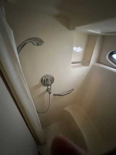 Ballerina Yacht Photos Pics Shower area in 2004 Sea Ray 390 Motor Yacht with modern fixtures and porthole window.