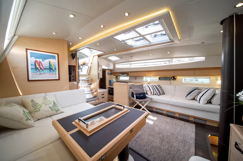 Serenity Yacht Photos Pics Luxurious interior of 2016 Jeanneau 64 yacht with elegant seating and modern decor.