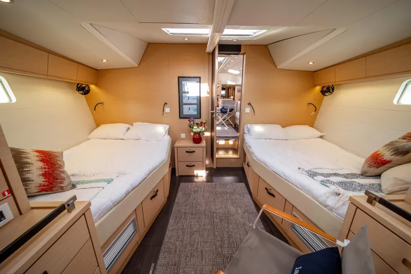 Serenity Yacht Photos Pics Luxurious interior of 2016 Jeanneau 64 yacht with twin beds and modern decor.