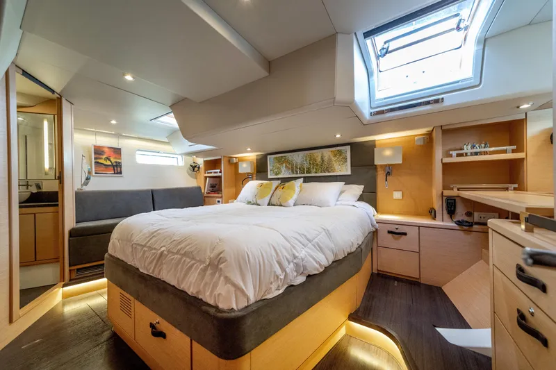 Serenity Yacht Photos Pics Luxurious 2016 Jeanneau 64 yacht bedroom with skylight, modern decor, and cozy ambiance.
