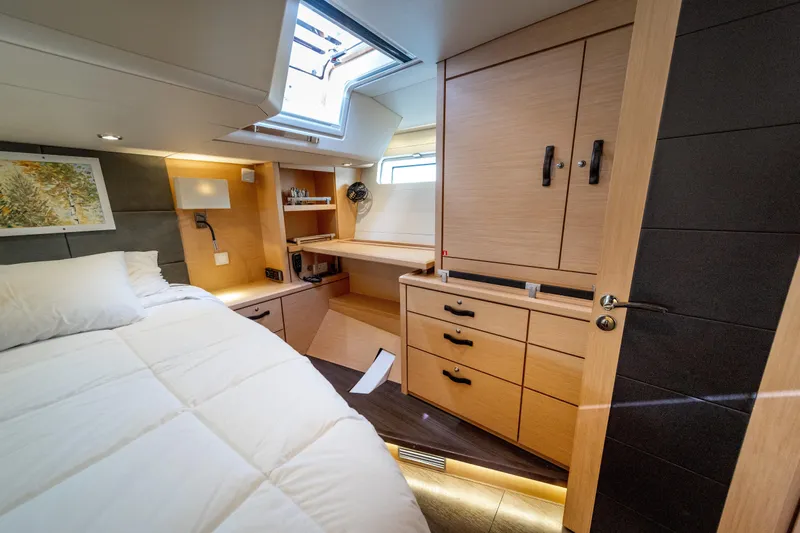 Serenity Yacht Photos Pics Luxurious 2016 Jeanneau 64 yacht cabin with modern wood furnishings and cozy bedding.