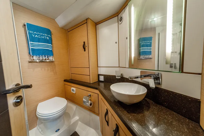 Serenity Yacht Photos Pics Luxurious bathroom in a 2016 Jeanneau 64 yacht with modern fixtures and elegant design.